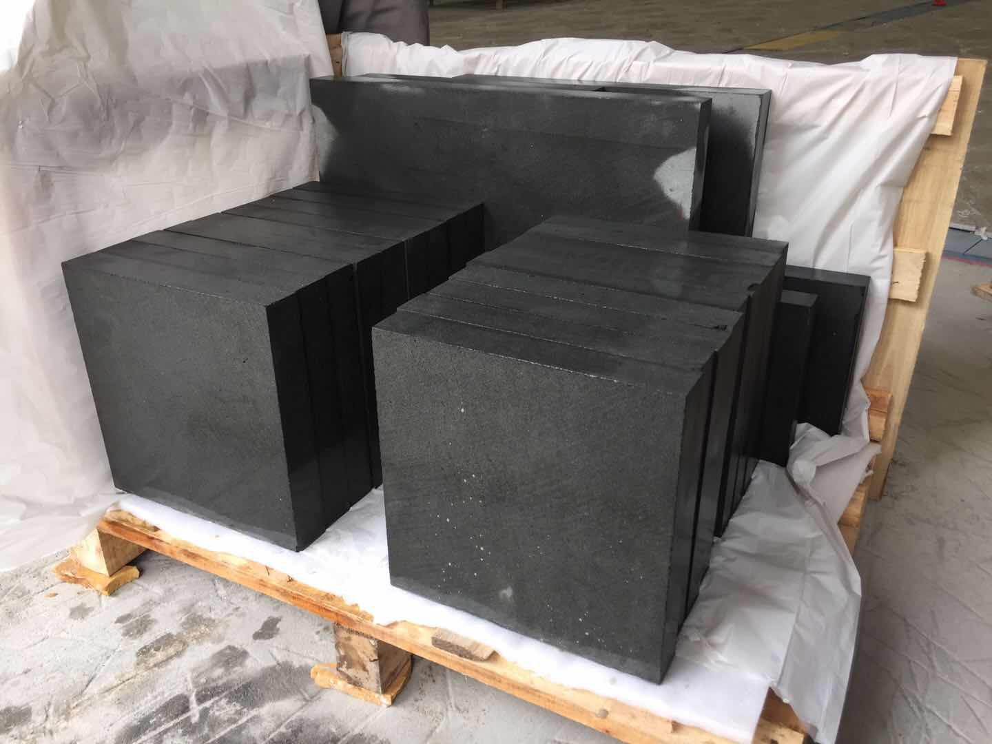 Black basalt blocks cut square and packed in a lined crate