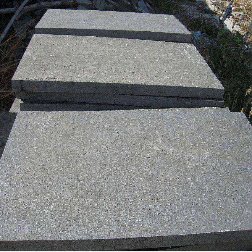 Flamed Nergo Black basalt tiles stacked after finishing, 600x600 and 600x300 mm