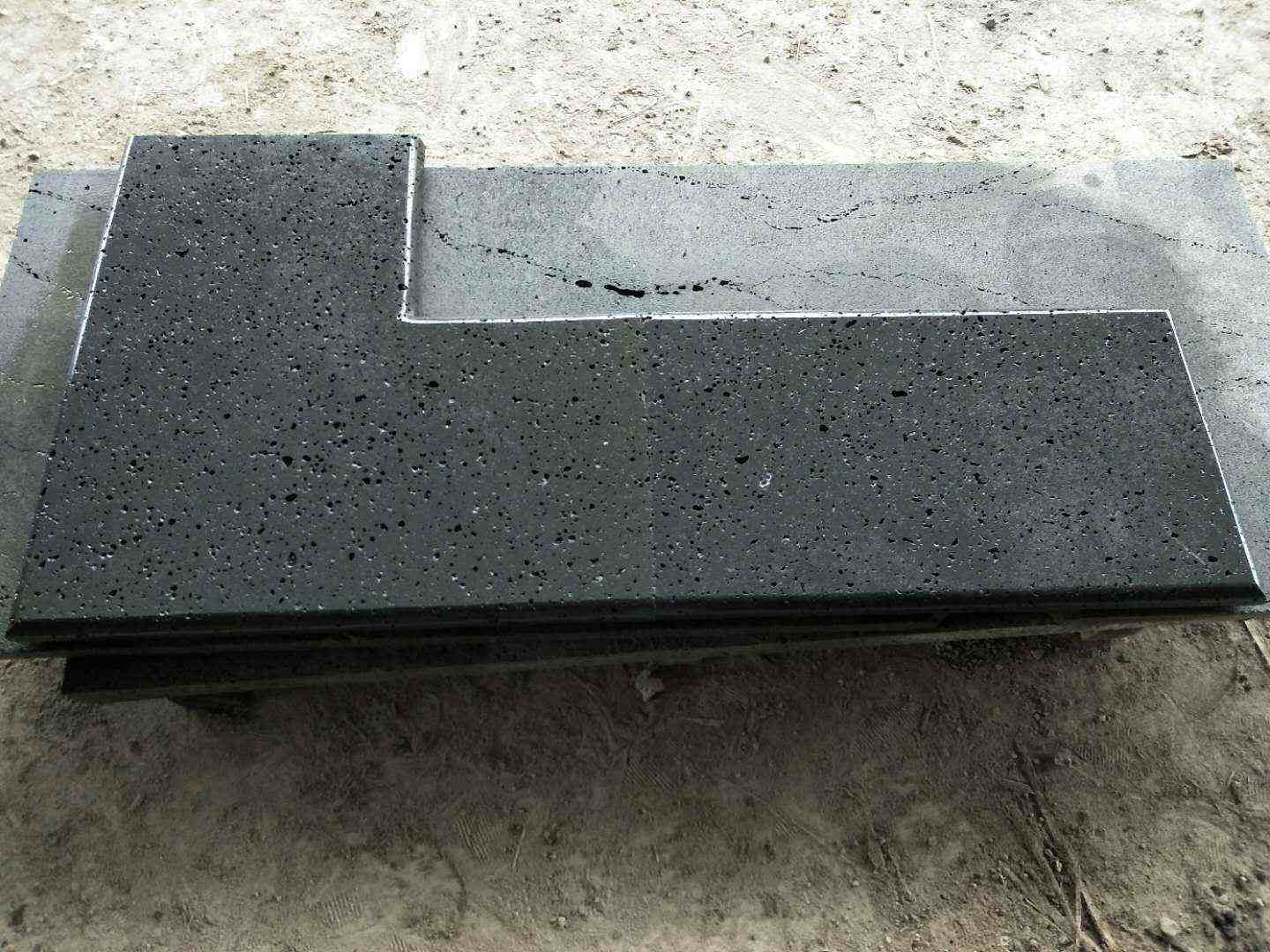 Black lava stone L-shaped coping with a bullnose edge