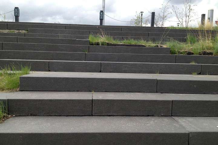 Wide outdoor seating steps built from basalt blocks