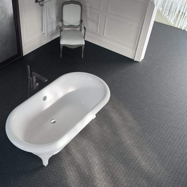 Black basalt mosaic floor in a bathroom with a freestanding tub