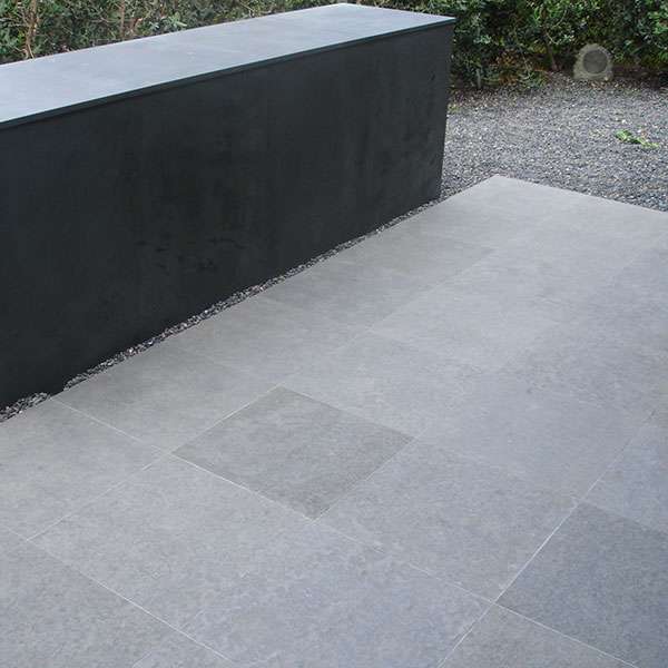 Grey basalt terrace paving with a black basalt block bench